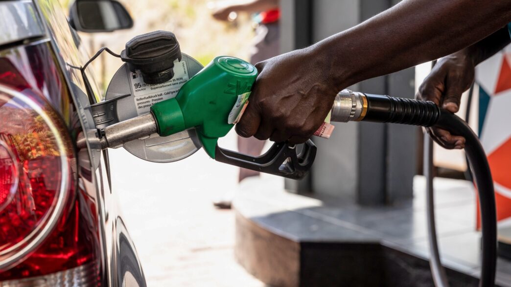 Fuel attendant refueling a car at the station.