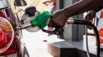 Fuel attendant refueling a car at the station.
