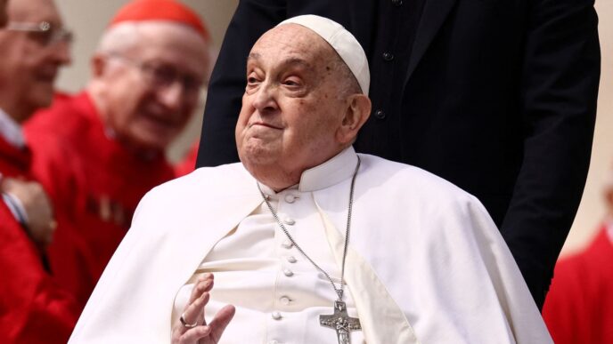 Pope Francis greets cardinals as he unexpectedly appears during the Palm Sunday Mass in Saint Peter's Square at the Vatican, April 13, 2025. Yara Nardi/Reuters