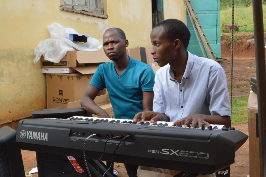 Deputy Prime Minister Thulisile Dladla hands over musical instruments to Nkosenomusa Sibaya Gamedze, a visually impaired musician, in a gesture of support for his musical career.