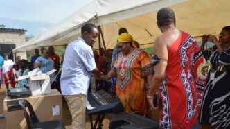 Deputy Prime Minister Thulisile Dladla hands over musical instruments to Nkosenomusa Sibaya Gamedze, a visually impaired musician, in a gesture of support for his musical career.
