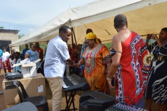 Deputy Prime Minister Thulisile Dladla hands over musical instruments to Nkosenomusa Sibaya Gamedze, a visually impaired musician, in a gesture of support for his musical career.