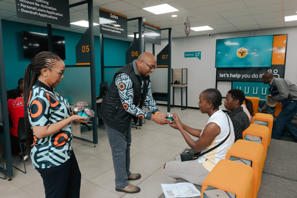 FNB Eswatini CEO Thokozani 'TK' Dlamini offers a cupcake in celebration of the bank’s 30th anniversary.