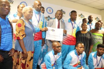 Minister Bongani Nzima presents cash rewards to Eswatini medalists for their international victories.