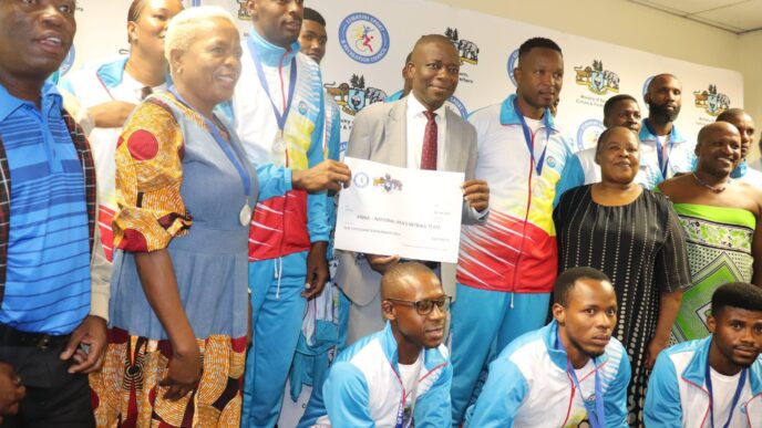 Minister Bongani Nzima presents cash rewards to Eswatini medalists for their international victories.