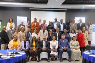 Stakeholders engage during the NDC 3.0 revision breakfast meeting in Mbabane.