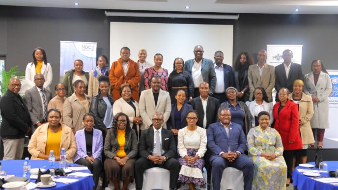 Stakeholders engage during the NDC 3.0 revision breakfast meeting in Mbabane.