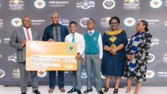 FNB Eswatini CEO Thokozani ‘TK’ Dlamini holds a symbolic cheque during the launch of the 2025 Entrepreneur of the Year Awards at Happy Valley Hotel.