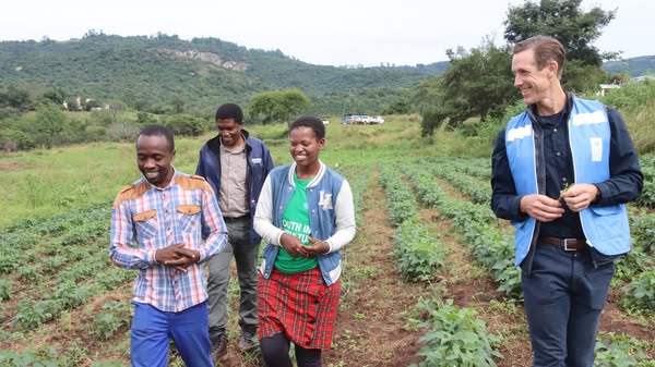 UNDP Resident Representative, Mr Henrik Franklin talks to the Malazas while touring their farm. UNDP/Mantoe Phakathi