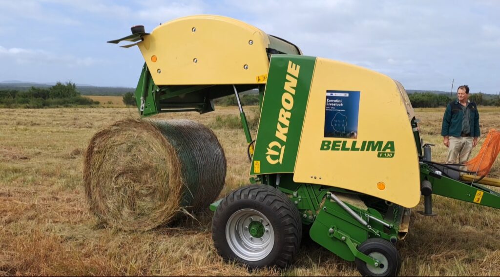 Part of the donated machinery on display at Mpisi, including round balers, mowers, rakes, and loaders for hay production.