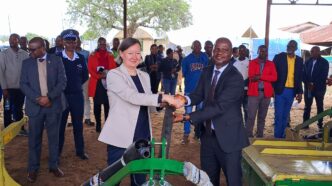 Minister of Agriculture Jabulani Mabuza and the European Union representative share a moment during the official handover of hay-making equipment worth E3.1 million at Mpisi Cattle Breeding Station.