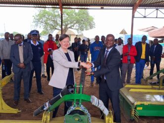 Minister of Agriculture Jabulani Mabuza and the European Union representative share a moment during the official handover of hay-making equipment worth E3.1 million at Mpisi Cattle Breeding Station.