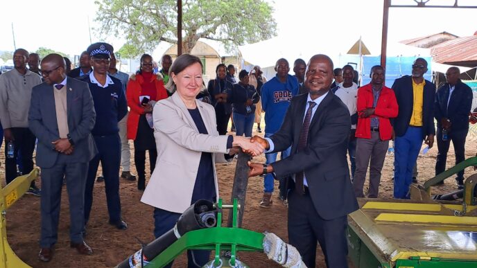 Minister of Agriculture Jabulani Mabuza and the European Union representative share a moment during the official handover of hay-making equipment worth E3.1 million at Mpisi Cattle Breeding Station.