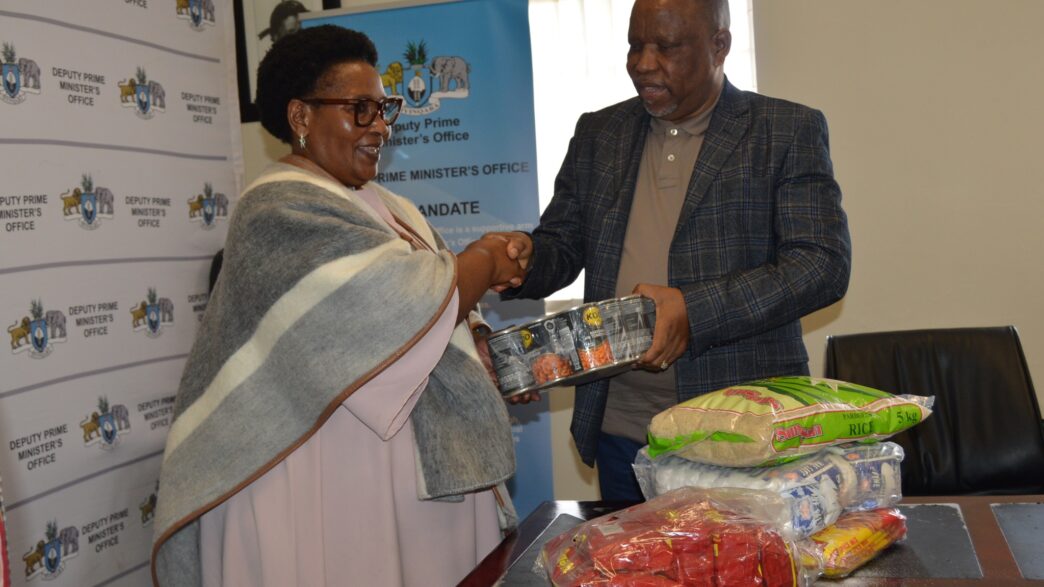 Deputy Prime Minister Thulisile Dladla receives food parcels from Reverend Johannes Mazibuko of Mbabane Alliance Church during the official handover ceremony at the DPM’s Office. The donation will support vulnerable communities across Eswatini. Photo by DPM Office
