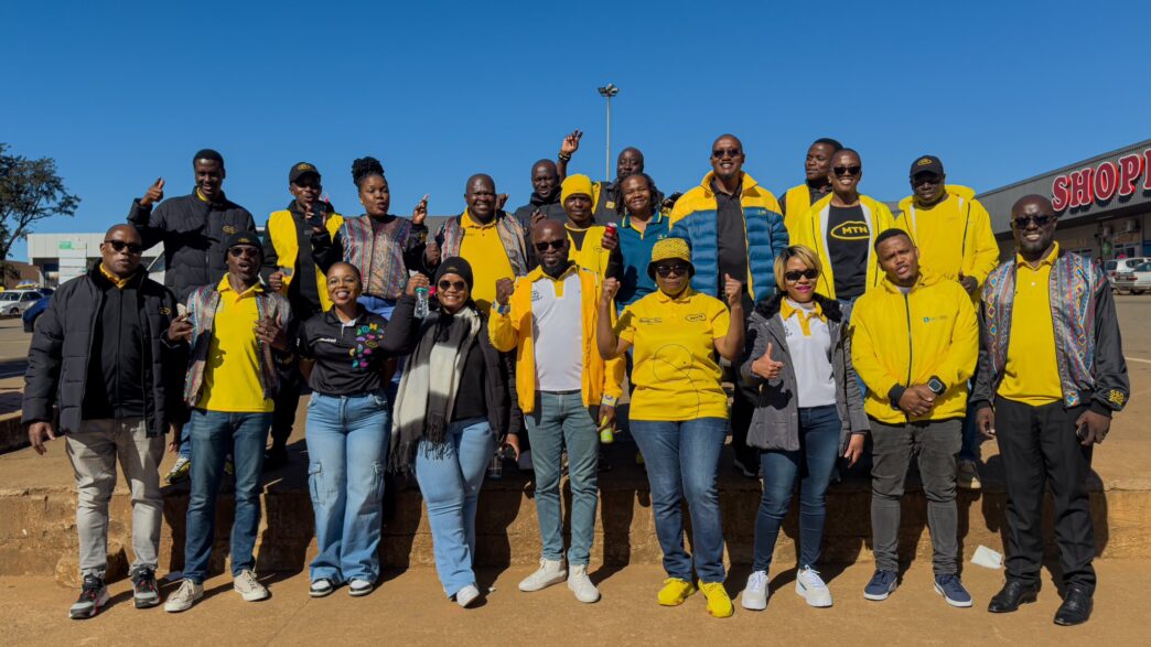 MTN Eswatini CEO Wandile Mtshali joins frontline staff for a group photo during the final stop of the nationwide roadshow in Nhlangano.
