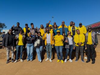 MTN Eswatini CEO Wandile Mtshali joins frontline staff for a group photo during the final stop of the nationwide roadshow in Nhlangano.