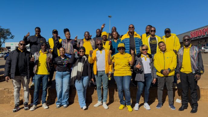 MTN Eswatini CEO Wandile Mtshali joins frontline staff for a group photo during the final stop of the nationwide roadshow in Nhlangano.
