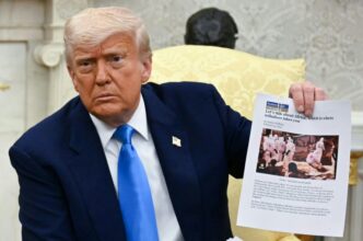 US President Donald Trump showed a sheaf of documents that he said was evidence of a 'genocide' against white farmers in South Africa (Jim WATSON)