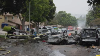 Several cars ignited after a small plane crashed into a San Diego neighborhood early Thursday. Gregory Bull/AP