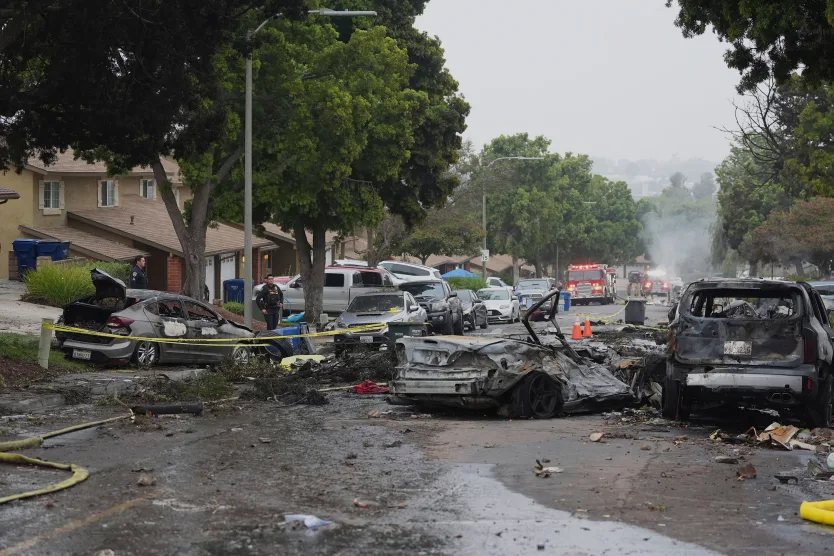 Several cars ignited after a small plane crashed into a San Diego neighborhood early Thursday. Gregory Bull/AP