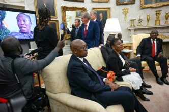A video is played as South African President Cyril Ramaphosa, right, looks on during a meeting with President Donald Trump in the Oval Office of the White House in Washington, DC, on May 21. Jim Watson/AFP/Getty Images