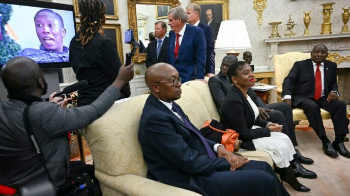 A video is played as South African President Cyril Ramaphosa, right, looks on during a meeting with President Donald Trump in the Oval Office of the White House in Washington, DC, on May 21. Jim Watson/AFP/Getty Images