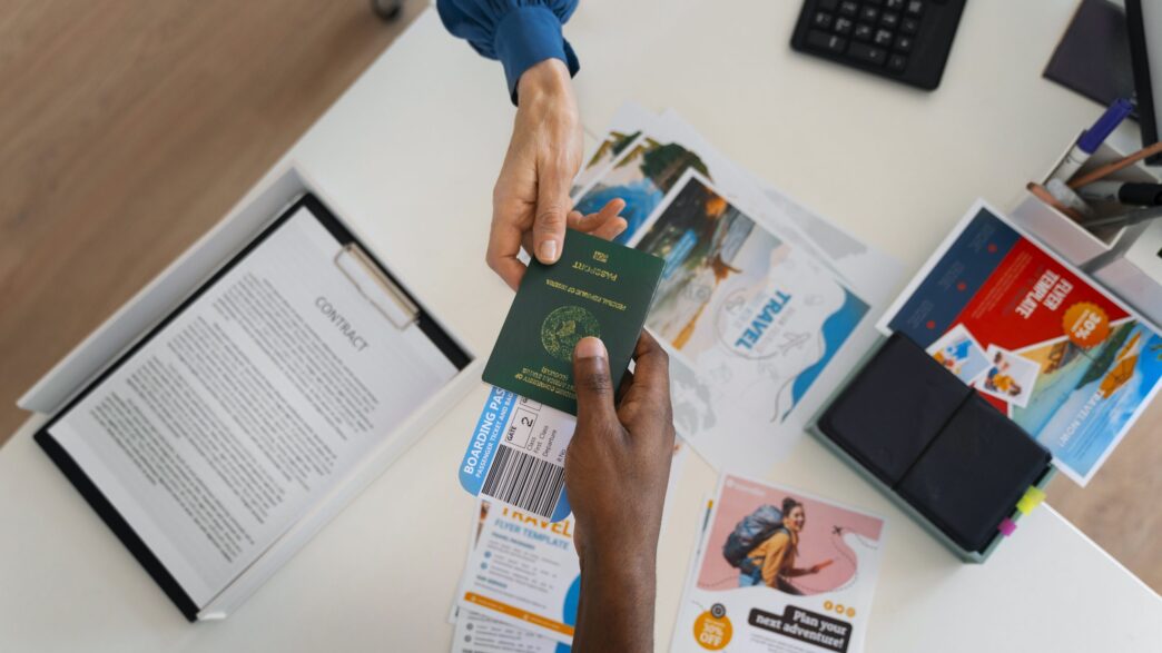 A traveller hands over his passport with a flight ticket tucked inside