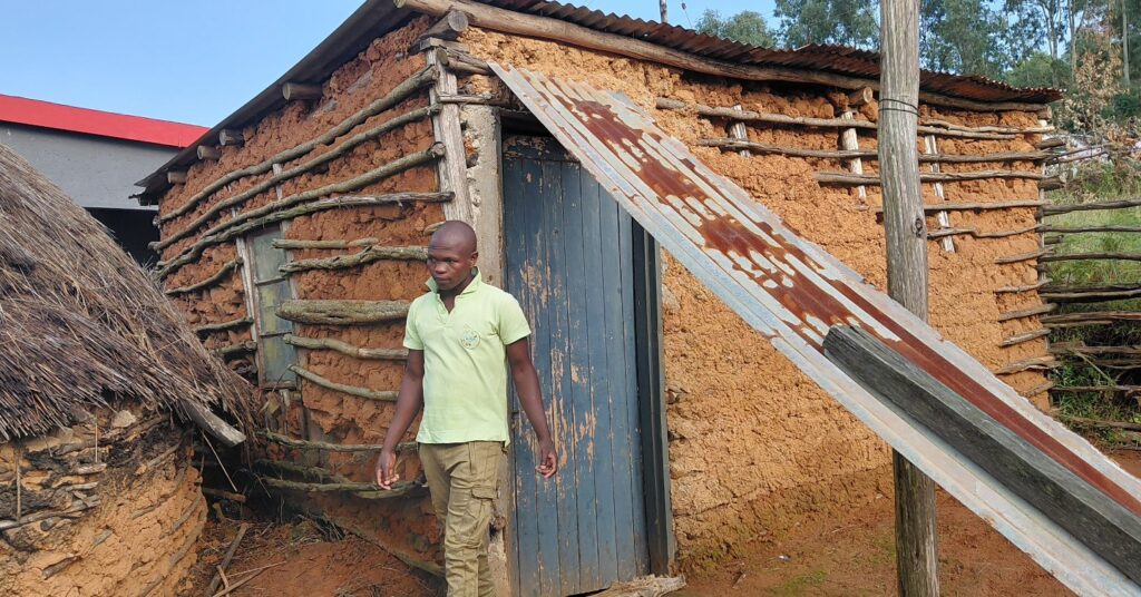 Mfanufikile Dlamini pictured next to the old structure he previously called home in Tiyeni KaLamgabhi.