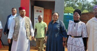 Tiyeni KaLamgabhi Deputy Prime Minister Thulisile Dladla and Mohammed Foundation Chairman Sayed Dlamini stand in front of the newly built house handed over to Mfanufikile Dlamini under Hhukwini Inkhundla.