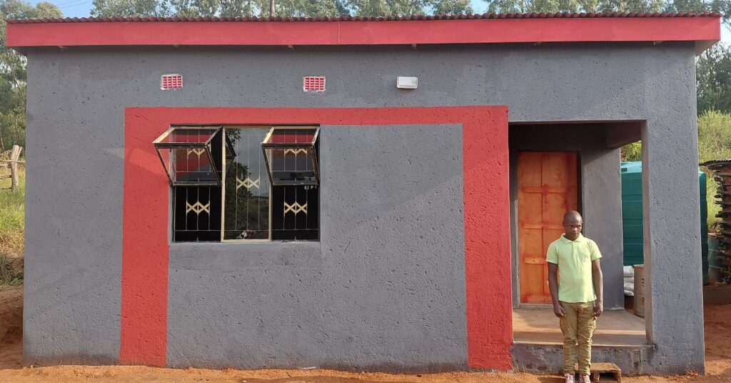 Mfanufikile Dlamini outside his newly constructed house in Tiyeni KaLamgabhi after the official handover ceremony.