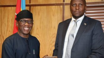 Prime Minister Russell Mmiso Dlamini receives the Effective Governance Peace Division award from African Union Commissioner Ambassador Bankole Adeoye at the Private and Cabinet Office in Mbabane.