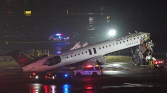 Emergency crews work around an Air Canada Express jet that had collided with a ground vehicle at New York's La Guardia Airport in Queens, New York, U.S. March 23, 2026. REUTERS/Bing Guan