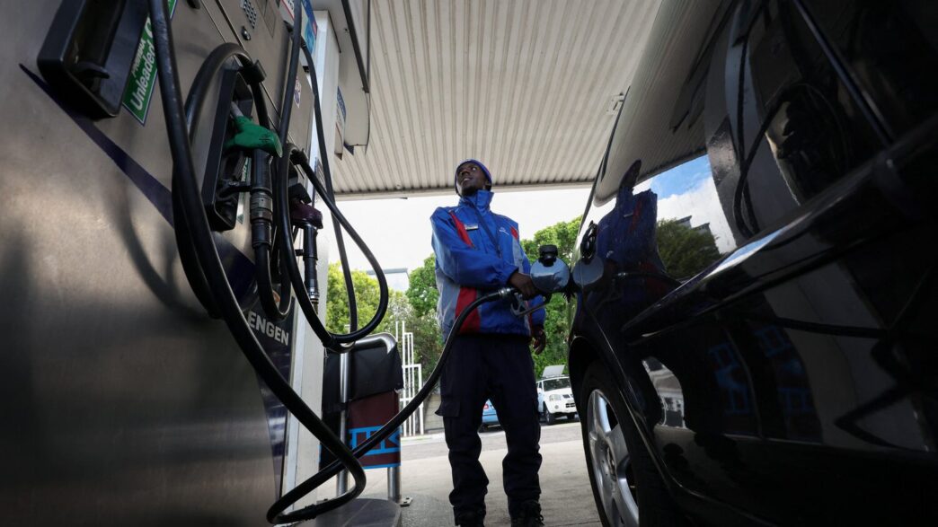 A worker fills a car at a petrol station in Cape Town, South Africa, March 25, 2026. REUTERS/Esa Alexander
