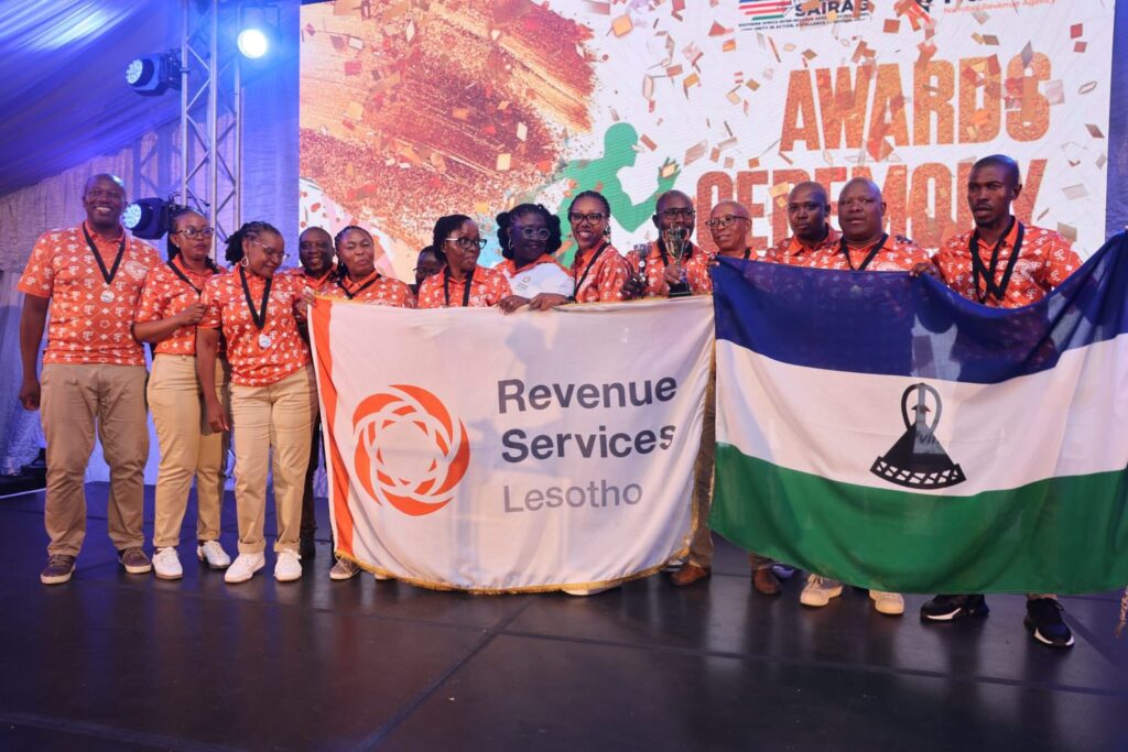 Team Lesotho celebrates their impressive medal haul at SAIRAG 2026, holding gold, silver, and bronze trophies won in individual and team events. Photo by RSL