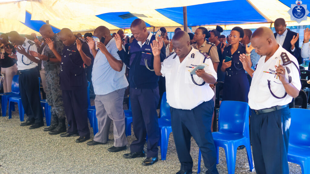 Officers bow their heads in prayer during the Easter service at Police Headquarters as they prepare for duty over the holiday weekend.