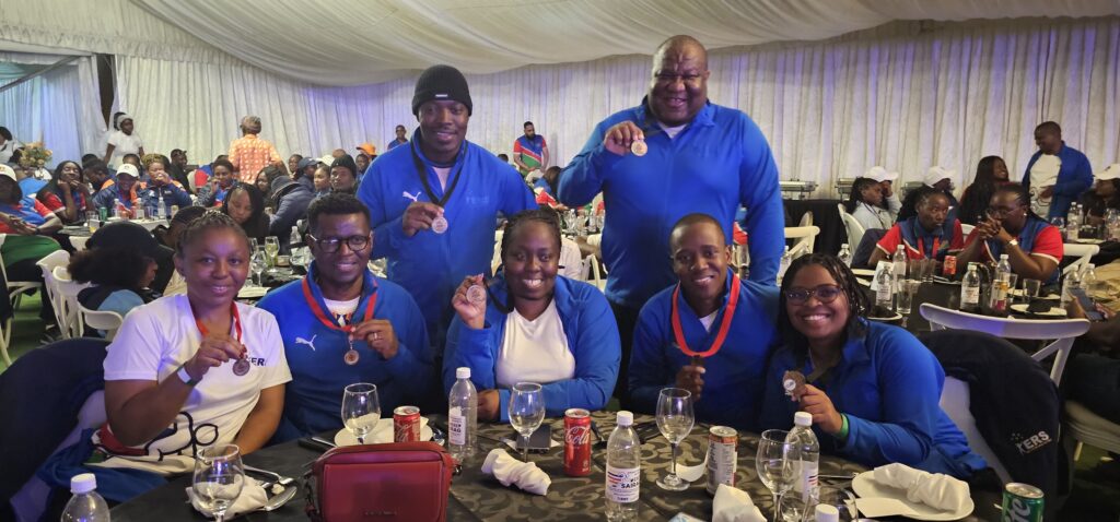 Eswatini Revenue Service athletes celebrate their medal haul in pool, table tennis, netball and chess during the SAIRAG 2026 awards ceremony in Swakopmund, Namibia. Photo by Eswatini Revenue Service.