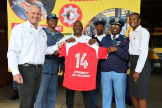 Officers of the Eswatini National Fire Rescue and Emergency Service pose with Stallion Integrated representatives after receiving new soccer kits at Matsapha Fire Station.
