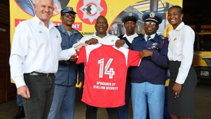 Officers of the Eswatini National Fire Rescue and Emergency Service pose with Stallion Integrated representatives after receiving new soccer kits at Matsapha Fire Station.