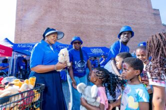 Minister for Foreign Affairs and International Cooperation Pholile Shakantu presents toys and gifts to children who attended the Embiveni Meats Candana Ja activation, bringing smiles to over 40 young guests. Photo by Tribe Studios.