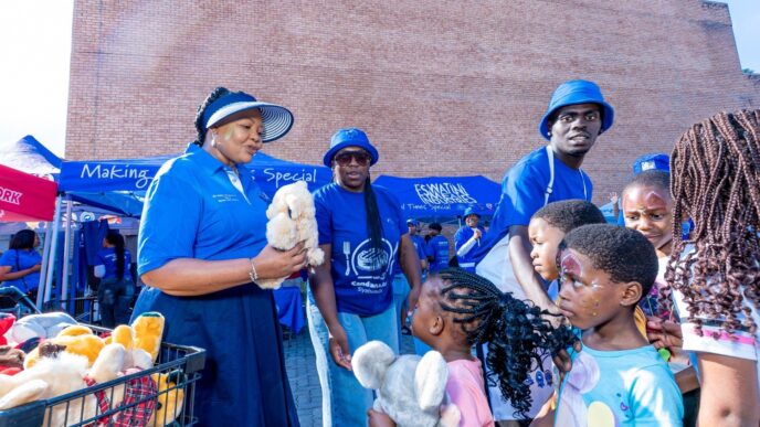 Minister for Foreign Affairs and International Cooperation Pholile Shakantu presents toys and gifts to children who attended the Embiveni Meats Candana Ja activation, bringing smiles to over 40 young guests. Photo by Tribe Studios.