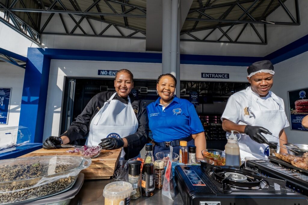 Minister for Foreign Affairs and International Cooperation Pholile Shakantu shares a light moment with award winning chef Lindelwa Makhanya during the Embiveni Meats Candana Ja activation at Mbabane Meat Plaza. Photo by Tribe Studios.