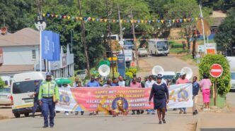 Community members, the Correctional Services Band and drum majorettes from St. Mary's Lobamba fill the streets of Pigg's Peak during the 40 Years of Reign Roadshow celebrating His Majesty King Mswati III's four decades on the throne, organised by the Ministry of Home Affairs in partnership with Pigg's Peak Town Council. Photo: Supplied