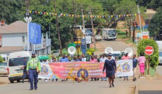 Community members, the Correctional Services Band and drum majorettes from St. Mary's Lobamba fill the streets of Pigg's Peak during the 40 Years of Reign Roadshow celebrating His Majesty King Mswati III's four decades on the throne, organised by the Ministry of Home Affairs in partnership with Pigg's Peak Town Council. Photo: Supplied