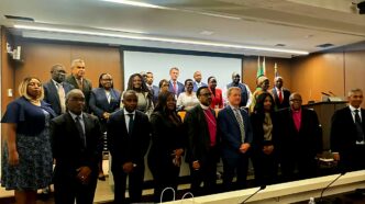Minister of Finance Neal Rijkenberg (centre) poses with Principal Secretary Vusie Dlamini and Director of Debt Management Armstrong Dlamini at the African Union Mission to the United States, where the Minister delivered remarks on digital and financial inclusion as Chairperson of the AU Specialized Technical Committee on Finance, Planning, Economic Integration and Monetary Affairs.