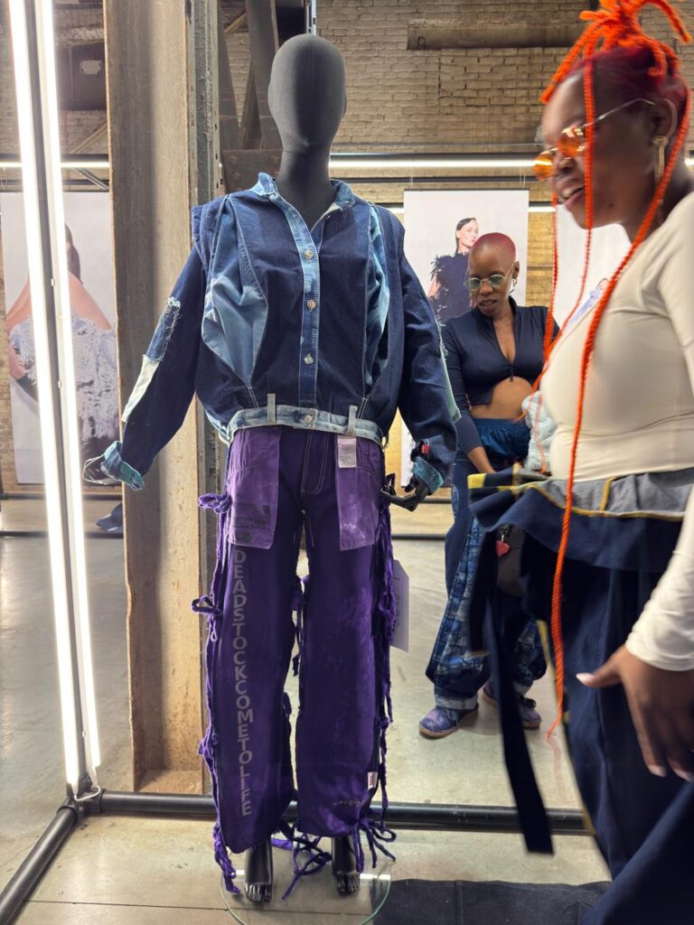Bohloeki and Boikokobetso Sibolla of Insyd/Owt Creatives display one of their reimagined pieces created from discarded Levi's 501 jeans as part of the Rescue501 mission at the Kingpins Show in Amsterdam in April 2026. Photo by EU in Lesotho