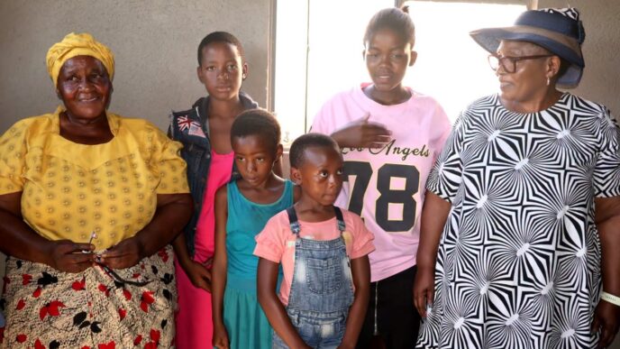 Deputy Prime Minister Thulisile Dladla pictured with beneficiary families during the official handover of three newly built homes at Bulandzeni, Ndzingeni Inkhundla, financed by the Roman Catholic Church through Caritas