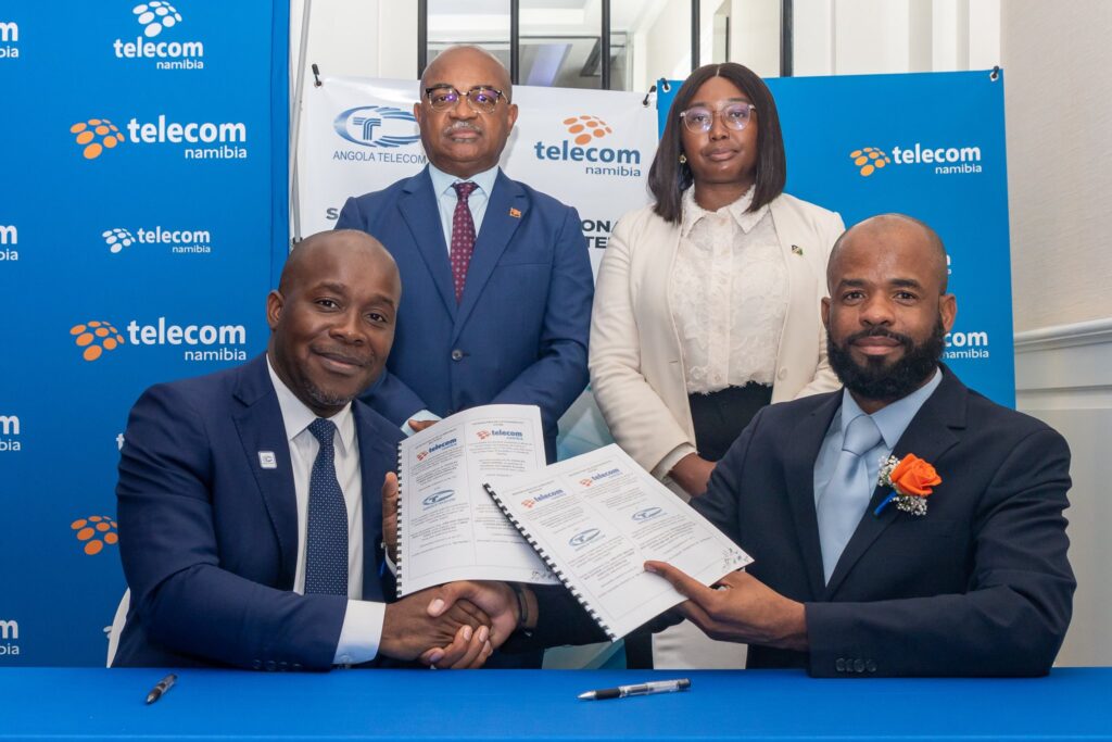 Telecom Namibia CEO Dr. Stanley Shanapinda and Angola Telecom CEO Adilson Miguel dos Santos exchange the signed Memorandum of Understanding and Commercial Terms Agreement in Swakopmund, marking a new chapter in digital cooperation between the two countries.