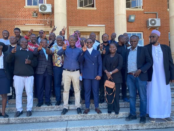 Zambia Civil Liberties Union Executive Director Isaac Mwanza and colleagues celebrate outside the Constitutional Court . Photo by NBC