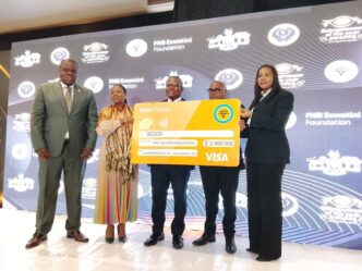 Minister of Commerce, Industry and Trade Manqoba Khumalo, SEDCO Board Chairperson Dr Mandlenkhosi Dlamini and SEDCO CEO Khethiwe Mhlanga receive a E2 million sponsorship cheque from FNB Eswatini at the launch of the 20th Entrepreneur of the Year Awards at Royal Villas, Ezulwini. Photo by Eswatini Financial Times