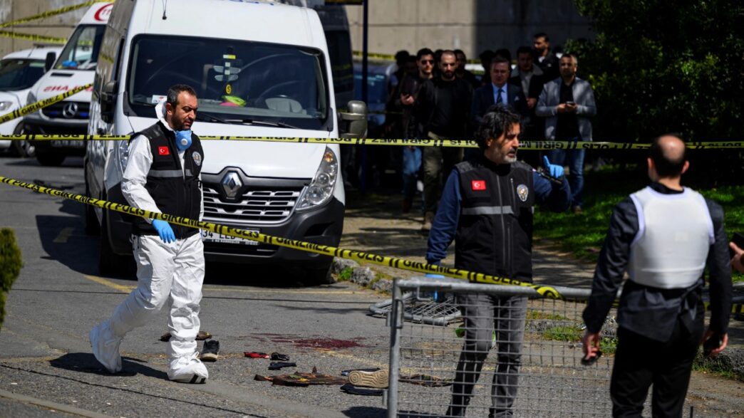 Police officials gather outside The Israeli Consulate in Istanbul following a shootout between gunmen and police [AFP]